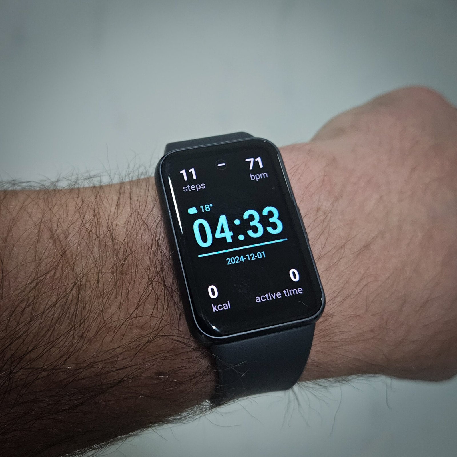 Samsung Galaxy Fit 3 smartwatch on wrist showing 04:33 time, 18°C temperature, 71 bpm heart rate, and December 1, 2024 date